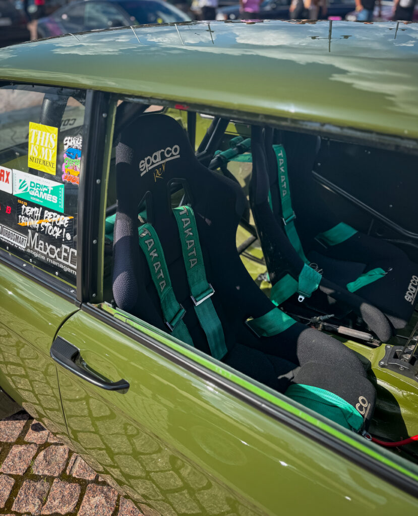 Green car with green seatbelts